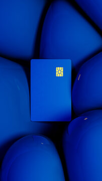 Bright blue credit card rests against a backdrop of vivid spheres