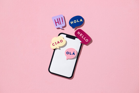 Multilingual Greetings with Smartphone on Pink Background