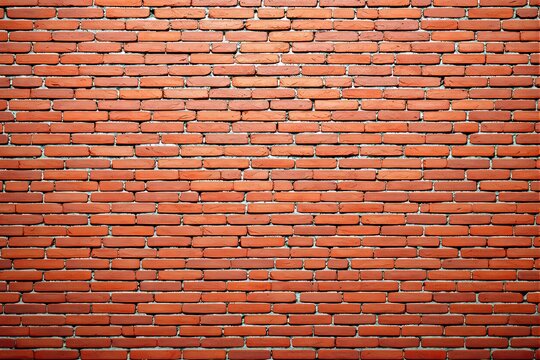 Fototapeta Close-up of a red brick wall with detailed texture, showing rustic imperfections. The bricks are neatly arranged, creating a structured background. Ai generative