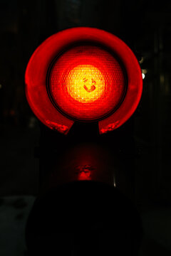 Close-Up of a smile sign on a Red Signal Light in Darkness