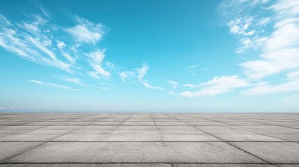 Empty plaza with blue sky and clouds. Ideal for background, design, or showcasing products.