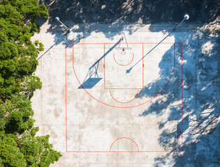 Aerial View Outdoor Basketball Court with Tree Shadows and Red L