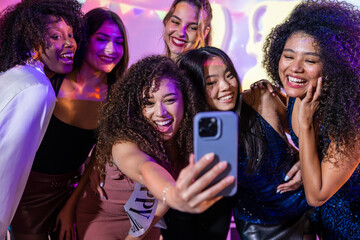 Friends capturing joyful moments at a vibrant party celebration