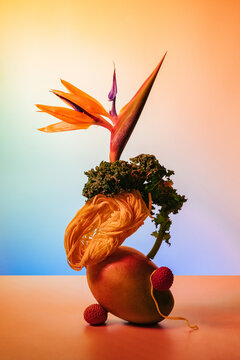 Creative fruit and vegetable arrangement with colorful background