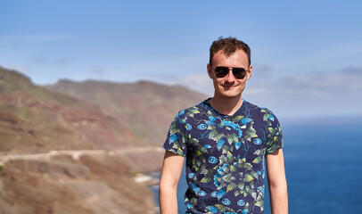 Smiling man with ocean backdrop in Tenerife........
