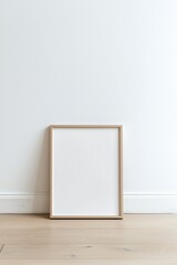 Minimalist Frame Mockup, Eye-Level Shot. Blank Poster on Wooden Floor Against White Wall. Empty Space, Interior Design, Artwork Display.