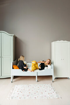 Family Bonding in a Cozy Bedroom Setting