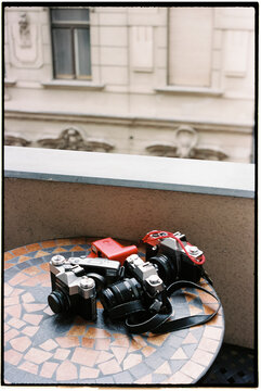 some cameras on a table on the balcony, 35mm
