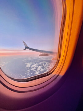 Commercial airplane wing at dusk