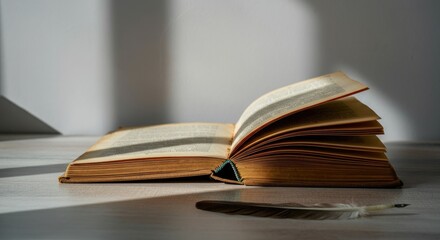Naklejka premium Open book on table with quill