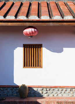 White walled Building with Red tiled Roof, Lantern and Wooden fr