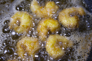 
it is  cooking shrimp tempura.