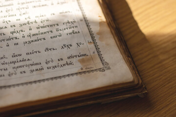 A book lies open to a particular page featuring Russian writing on it