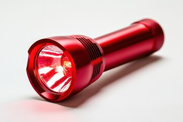 A red metal flashlight illuminating a bright beam of light