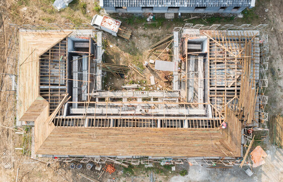 Aerial View of Active Construction Site with Wooden Roof Framing