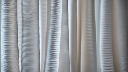 Textured white lamella curtains in soft natural light showcasing elegant folds with varying depths and a subtle sheen background.