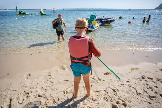 family relaxing on the beach