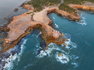 Rugged coastline with a monument on a rock ledge