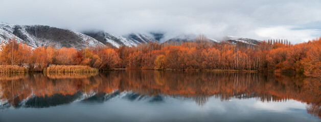 Dramatic Autumn reflections panorama