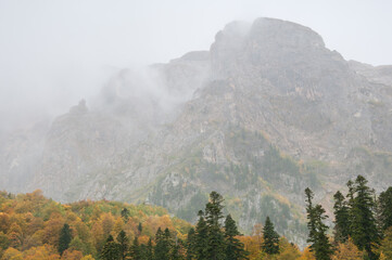 Peak of the Mount Fisht covered with fog in the autumn morning, Republic of Adygea, Russia