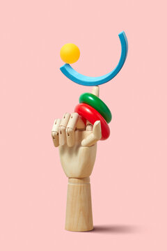 Balanced color figures on wooden hand