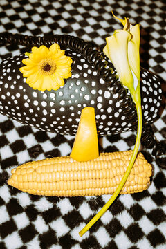Veggies and flowers artistically arranged on a pattern