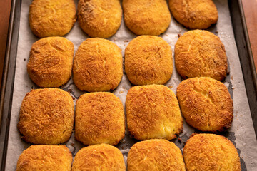 Cottage cheese pancakes on a baking sheet.Dessert.Syrniki
