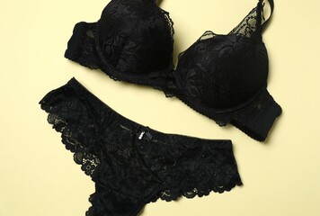 Flat lay with women romantic underwear on beige background, top view