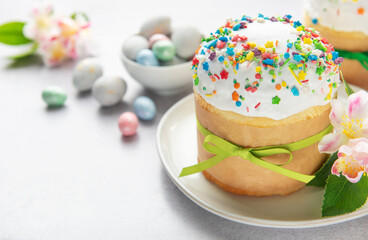 Delicious easter cake decorated with colorful sprinkles and green ribbon