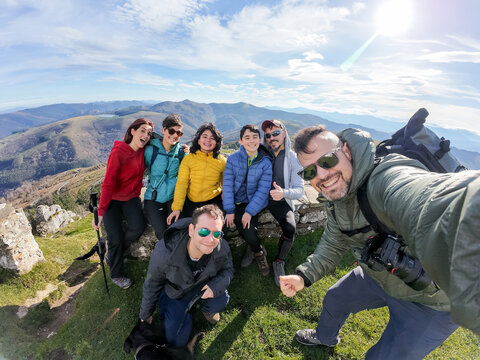 Hikers taking selfie on top of mountain in Spain