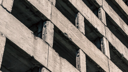 abstract background fragment of a concrete block building with empty windows