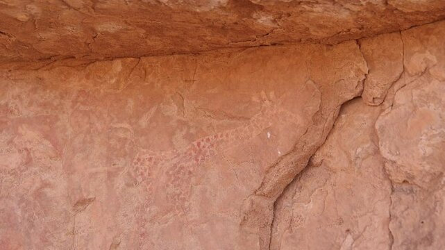 Neolithic rock art. Rock painting of a camel with rider. Tadrart Rouge. Tassili N'Ajjer National Park. Sahara Algerian Desert