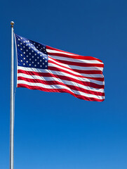 Fototapeta premium United States flag waving against clear blue sky