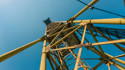old high metal tower building with stairs bottom view