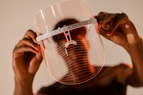 Hands Holding LED Face Shield