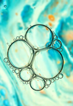 Abstract background with many colorful bubbles on blue backdrop.