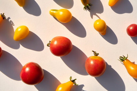 Variety of small cherry tomatoes making natural pattern under sunlight