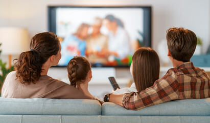 family watching  TV in the evening at home
