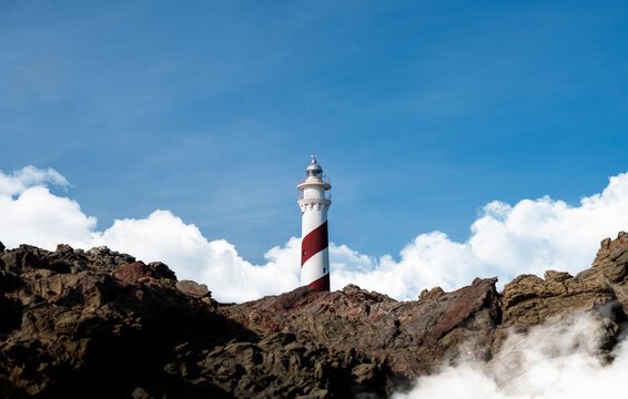 Scenic lighthouse with white clouds