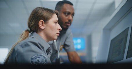 Airport Security Checkpoint: Two Diverse TSA Workers Monitoring Baggage Screening Procedure on Computer Monitors Using Modern Analyzing Program. Advanced X-ray Scanning Technology, Metal Detector.