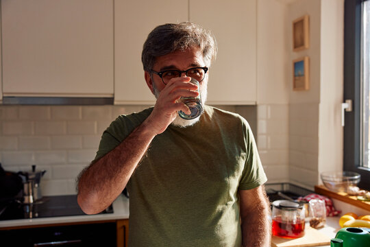 Man drinks water from a glass