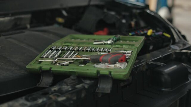 Replacement and repair of auto engine control unit chips.A set of different car keys.Box with keys for car repair.Repair of car electrical wiring under the engine.
