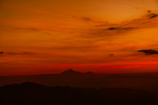 Majestic pico de orizaba volcano emerging from a fiery sunset