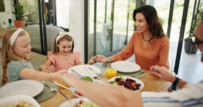 Children, praying and holding hands at lunch in family home with food, bonding and faith with smile. Parents, kids and gratitude with religion, love and connection with diet at Easter in dining room
