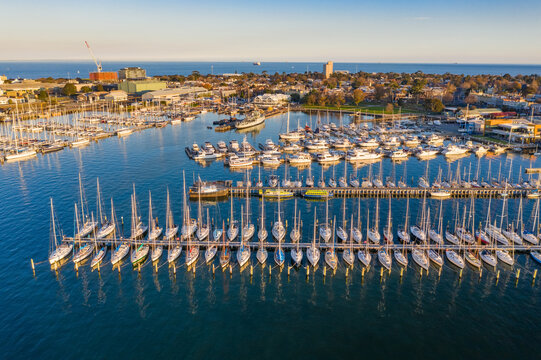 Rows of yachts moored a long pier