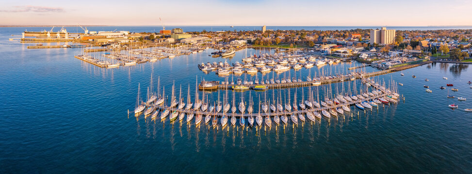 Rows of yachts moored a long pier