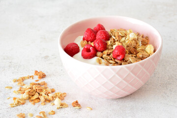 Yogurt bowl with granola and fresh raspberries