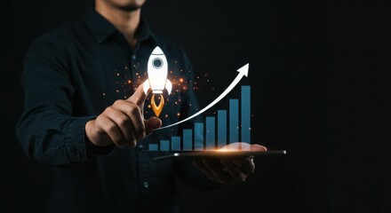 Young asian male touching rocket icon with growth chart in tablet