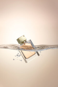 Perfume Bottle Submerged in Water Against Soft Background