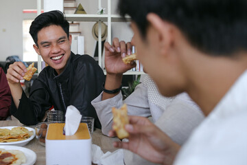 Diverse Happy Muslim Friends Break Fasting Together on Iftar Time at Home